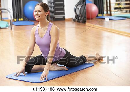 Woman Doing Stretching Exercises In Gym View Large Photo Image Stock Photo - Woman Doing Stretching Exercises In Gym. Fotosearch