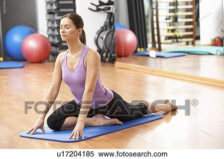 Stock Photography - Woman Doing Stretching Exercises In Gym. Fotosearch