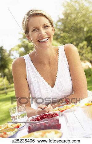 Woman Enjoying Meal In Garden View Large Photo Image Stock Photograph - Woman Enjoying Meal In Garden. Fotosearch