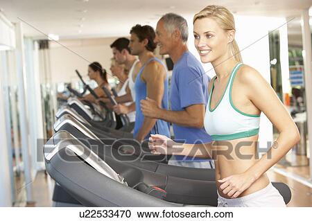 Stock Image - Woman On Running Machine In Gym. Fotosearch