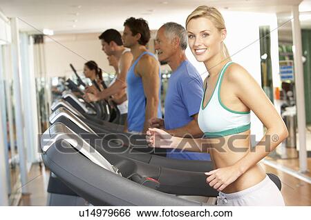 Stock Photograph - Woman On Running Machine In Gym. Fotosearch