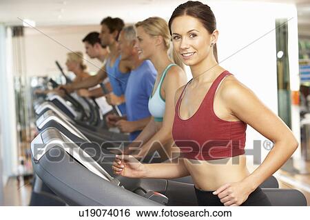 Stock Photograph - Woman On Running Machine In Gym. Fotosearch