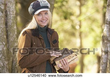 Woman Outdoors In Autumn Woodland Gathering Logs View Large Photo Image Stock Image - Woman Outdoors In Autumn Woodland Gathering Logs. Fotosearch