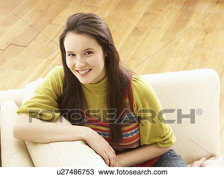 Woman Relaxing On Sofa At Home View Large Photo Image Stock Image - Woman Relaxing On Sofa At Home. Fotosearch