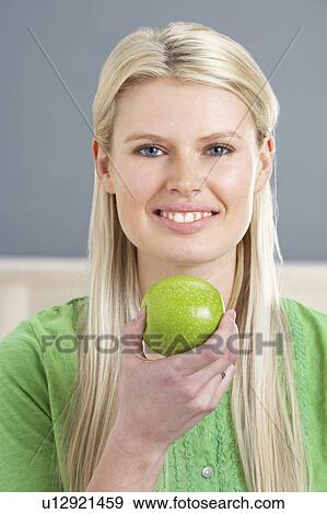 Woman Relaxing On Sofa Eating Apple At Home View Large Photo Image Stock Photo - Woman Relaxing On Sofa Eating Apple At Home. Fotosearch
