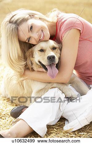 Woman Sitting With Dog On Straw Bales In Harvested Field View Large Photo Image Stock Photo - Woman Sitting With Dog On Straw Bales In Harvested Field. Fotosearch