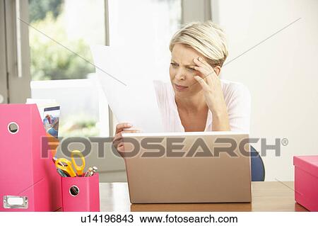 Stock Image - Woman Using Laptop At Home. Fotosearch