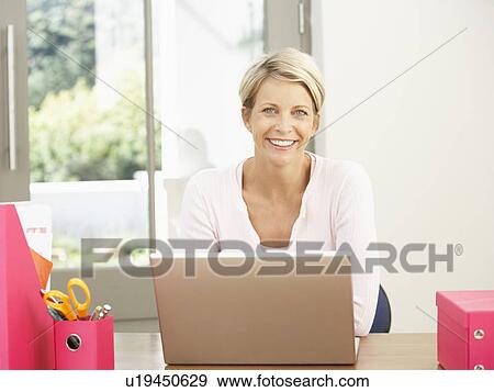 Stock Photo - Woman Using Laptop At Home. Fotosearch