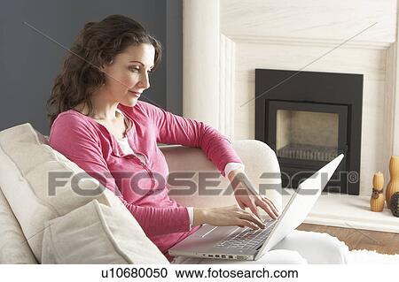 Woman Using Laptop Relaxing Sitting On Sofa At Home View Large Photo Image Stock Image - Woman Using Laptop Relaxing Sitting On Sofa At Home . Fotosearch