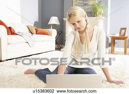Woman Using Laptop Relaxing Sitting On Rug At Home View Large Photo Image Stock Image - Woman Using Laptop Relaxing Sitting On Rug At Home. Fotosearch