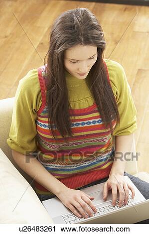 Woman Using Laptop Relaxing Sitting On Sofa At Home View Large Photo Image Stock Image - Woman Using Laptop Relaxing Sitting On Sofa At Home . Fotosearch