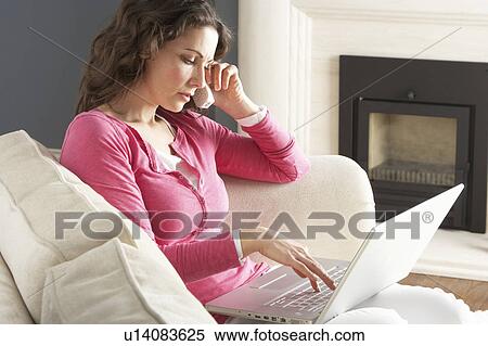 Woman Using Laptop Relaxing Sitting On Sofa At Home Talking On Phone View Large Photo Image Stock Photography - Woman Using Laptop Relaxing Sitting On Sofa At Home Talking On Phone. Fotosearch
