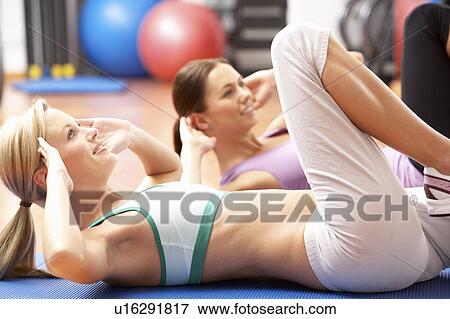 Stock Photo - Women Doing Stretching Exercises In Gym. Fotosearch