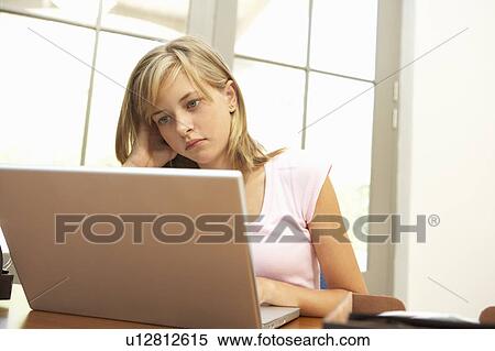 Worried Looking Teenage Girl Using Laptop At Home View Large Photo Image Stock Photography - Worried Looking Teenage Girl Using Laptop At Home. Fotosearch