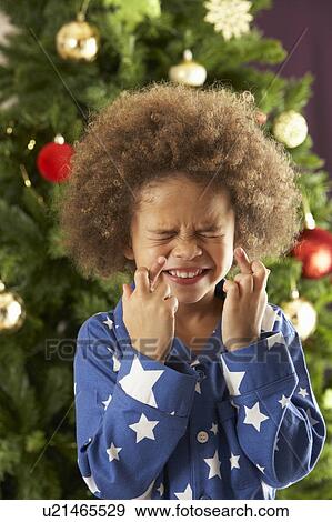 Young Boy Crossing Fingers In Front Of Christmas Tree View Large Photo Image Stock Photo - Young Boy Crossing Fingers In Front Of Christmas Tree. Fotosearch