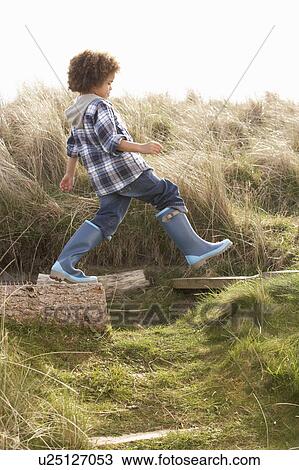 Young Boy Going For Walk In Wellington Boots View Large Photo Image Stock Image - Young Boy Going For Walk In Wellington Boots. Fotosearch