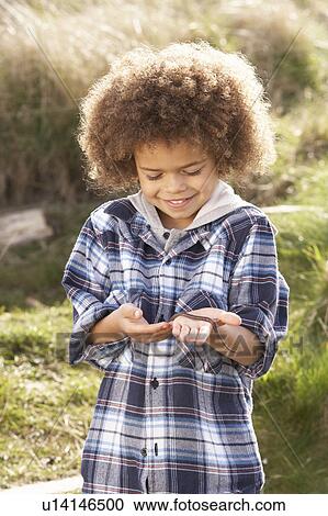 Young Boy Holding Worm Outdoors View Large Photo Image Stock Image - Young Boy Holding Worm Outdoors. Fotosearch