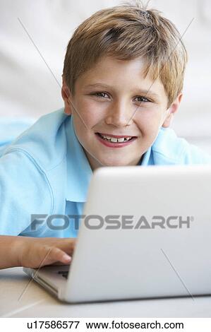 Young boy on his laptop computer View Large Photo Image Stock Photo - Young boy on his laptop computer. Fotosearch