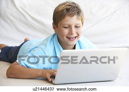 Stock Photo - Young boy on his laptop computer. Fotosearch