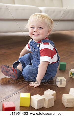 Young Boy Playing With Coloured Blocks At Home View Large Photo Image Stock Image - Young Boy Playing With Coloured Blocks At Home. Fotosearch