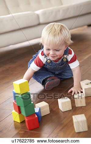 Young Boy Playing With Coloured Blocks At Home View Large Photo Image Stock Photography - Young Boy Playing With Coloured Blocks At Home. Fotosearch