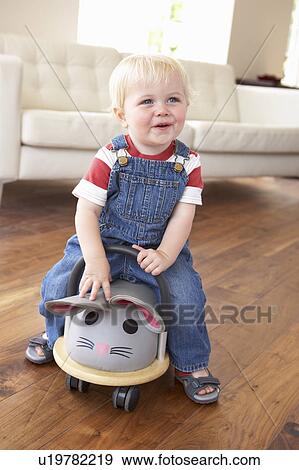 Young Boy Playing With Ride On Toy Mouse At Home View Large Photo Image Stock Photo - Young Boy Playing With Ride On Toy Mouse At Home. Fotosearch