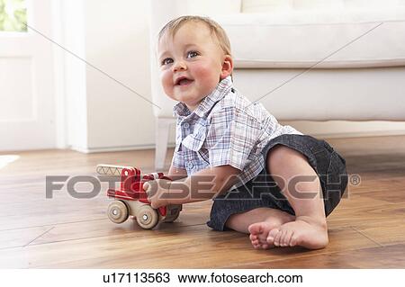 Young Boy Playing With Wooden Toy Car At Home View Large Photo Image Stock Image - Young Boy Playing With Wooden Toy Car At Home. Fotosearch