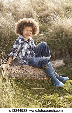 Young Boy Putting On Wellington Boots View Large Photo Image Stock Photo - Young Boy Putting On Wellington Boots. Fotosearch