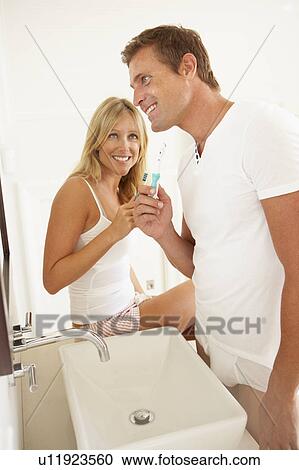 Young Couple Brushing Teeth In Bathroom View Large Photo Image Stock Image - Young Couple Brushing Teeth In Bathroom. Fotosearch