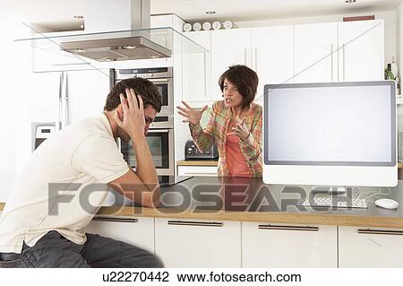 Young Couple Discussing Personal Finances In Modern Kitchen View Large Photo Image Stock Image - Young Couple Discussing Personal Finances In Modern Kitchen . Fotosearch