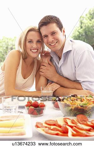 Young couple eating outdoors View Large Photo Image Stock Image - Young couple eating outdoors. Fotosearch