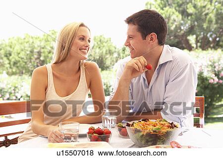 Young couple eating outdoors View Large Photo Image Stock Photo - Young couple eating outdoors. Fotosearch