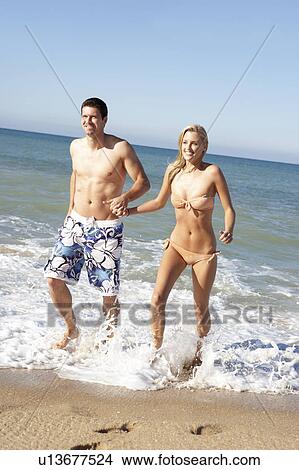 Young Couple Enjoying Beach Holiday View Large Photo Image Picture - Young Couple Enjoying Beach Holiday. Fotosearch