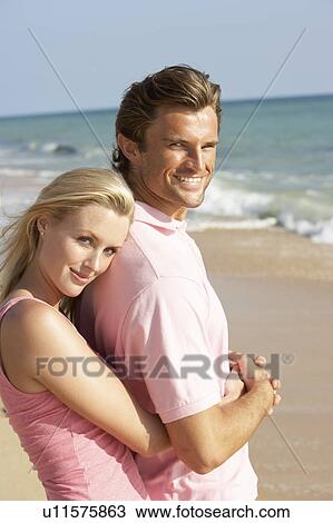 Young Couple Enjoying Beach Holiday View Large Photo Image Stock Image - Young Couple Enjoying Beach Holiday. Fotosearch