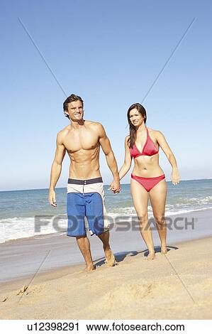 Young Couple Enjoying Beach Holiday View Large Photo Image Stock Image - Young Couple Enjoying Beach Holiday. Fotosearch