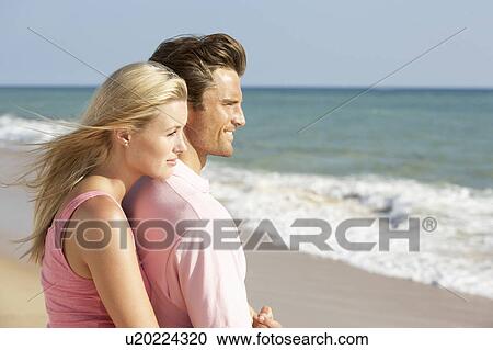 Stock Image - Young Couple Enjoying Beach Holiday. Fotosearch
