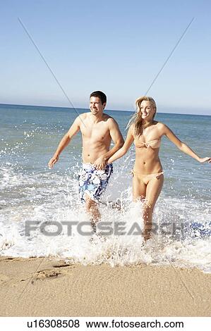 Young Couple Enjoying Beach Holiday View Large Photo Image Stock Photo - Young Couple Enjoying Beach Holiday. Fotosearch