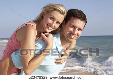 Young Couple Enjoying Beach Holiday View Large Photo Image Stock Photo - Young Couple Enjoying Beach Holiday. Fotosearch