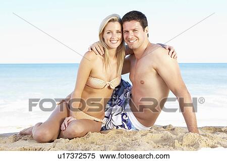 Stock Photography - Young Couple Enjoying Beach Holiday. Fotosearch