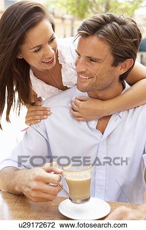 Stock Image - Young Couple Enjoying Coffee And Cake In Café. Fotosearch