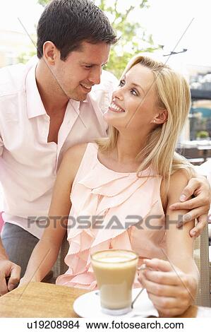 Young Couple Enjoying Coffee In Café View Large Photo Image Picture - Young Couple Enjoying Coffee In Café. Fotosearch