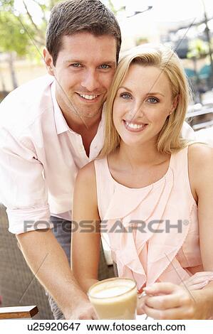 Stock Photo - Young Couple Enjoying Coffee In Café. Fotosearch