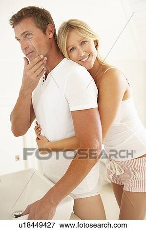 Stock Photo - Young Couple Getting Ready In Bathroom. Fotosearch