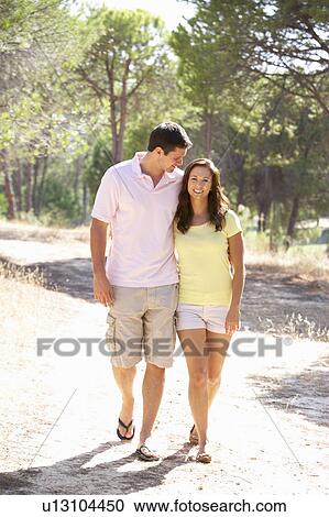 Young couple, holding hands, walking, walk in park View Large Photo Image Stock Image - Young couple, holding hands, walking, walk in park. Fotosearch