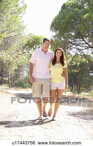 Young couple, holding hands, walking, walk in park View Large Photo Image Stock Photograph - Young couple, holding hands, walking, walk in park. Fotosearch
