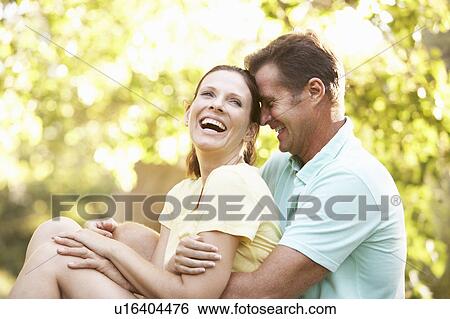 Young Couple In Walking Clothes Resting On Tree In Park View Large Photo Image Stock Photograph - Young Couple In Walking Clothes Resting On Tree In Park. Fotosearch