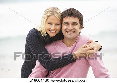 Young Couple On Holiday Sitting On Winter Beach View Large Photo Image Stock Image - Young Couple On Holiday Sitting On Winter Beach. Fotosearch