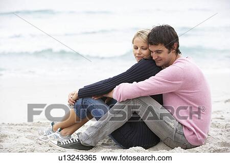 Young Couple On Holiday Sitting On Winter Beach View Large Photo Image Stock Photography - Young Couple On Holiday Sitting On Winter Beach. Fotosearch