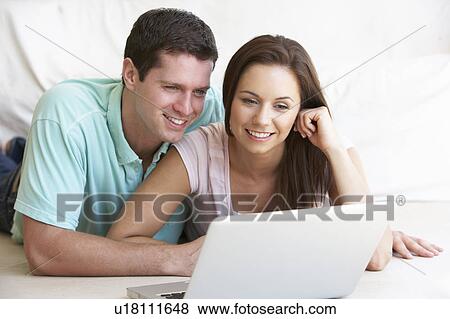 Young couple on laptop computer View Large Photo Image Stock Photo - Young couple on laptop computer. Fotosearch