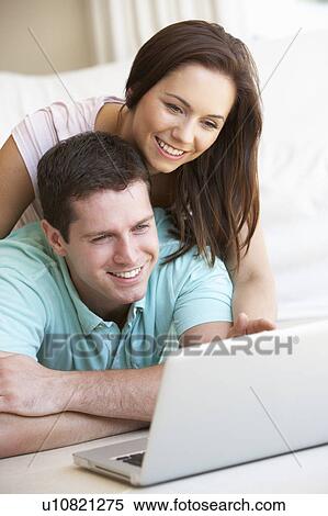 Young couple on laptop computer View Large Photo Image Stock Photography - Young couple on laptop computer. Fotosearch